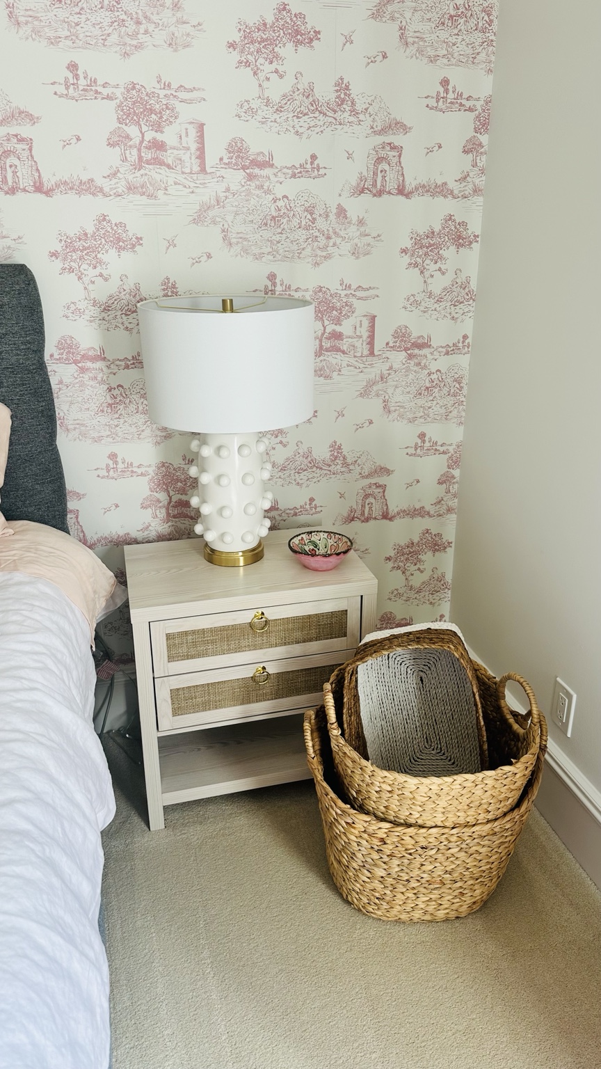 A pink toile bedroom corner styled with thoughtful home finds