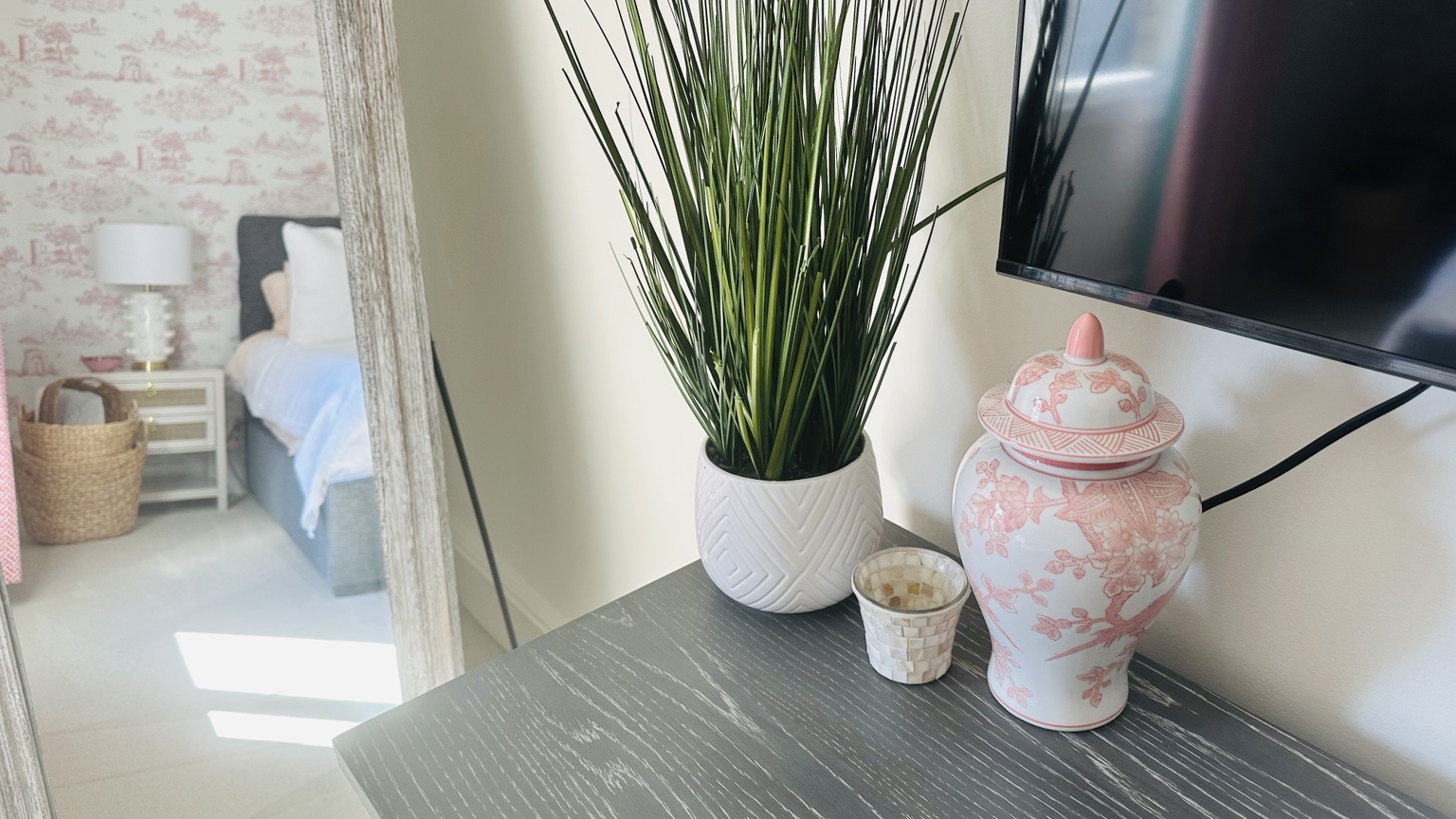 Pink chinoiserie ginger jar styled on bedroom dresser